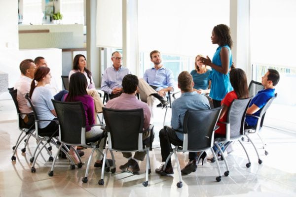 coach speaking in group coaching circle