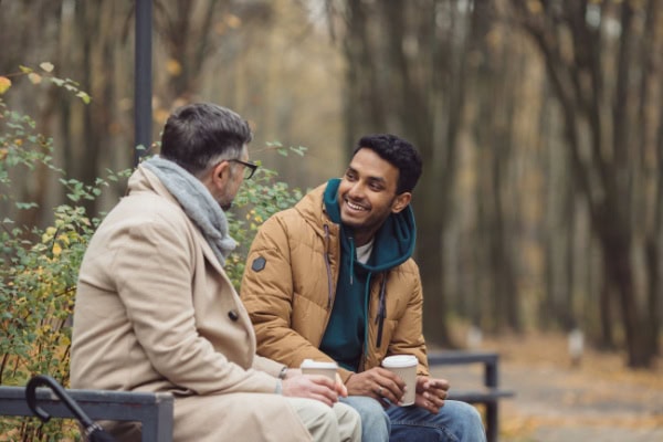 client and coach meeting in a park during a cool day