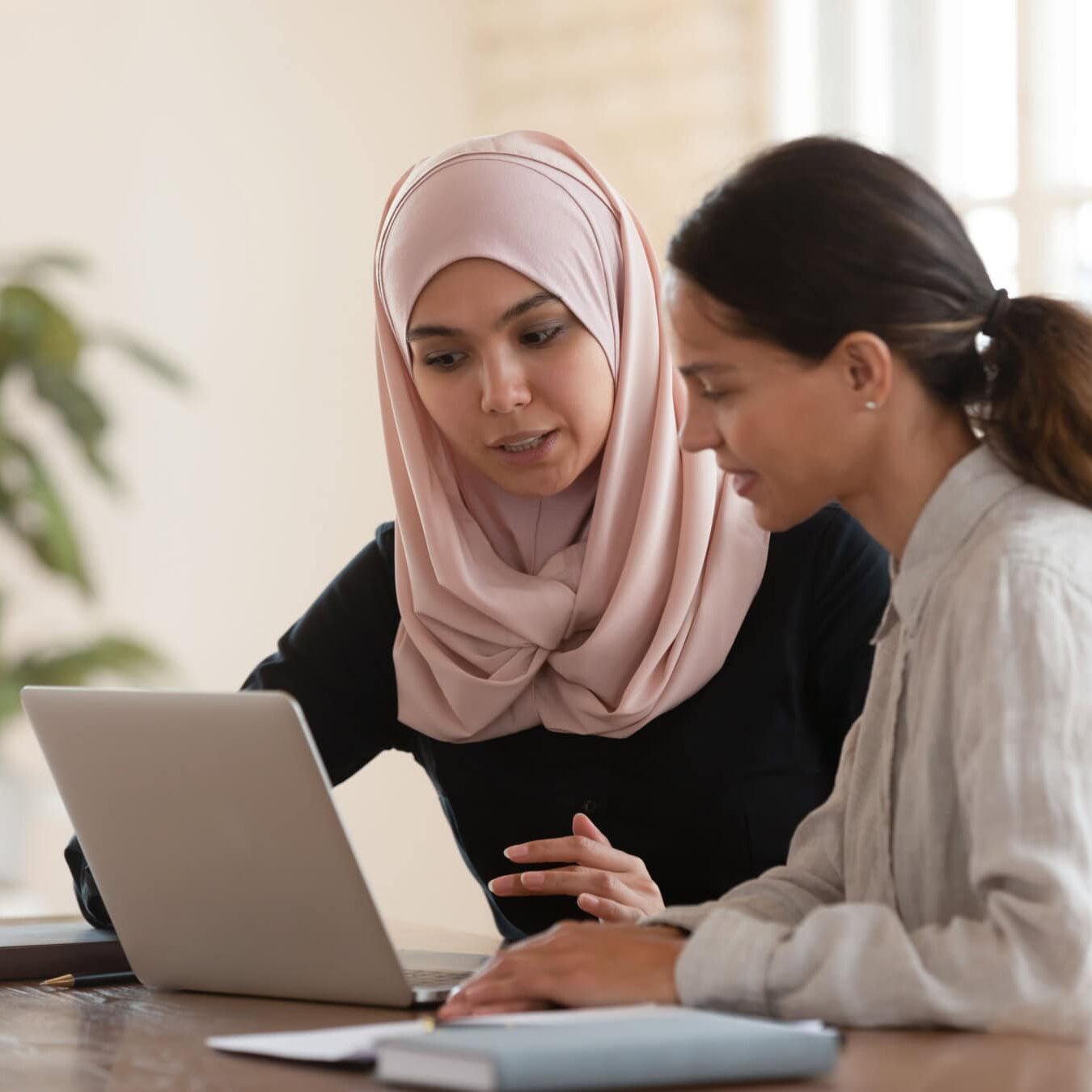 Two woman review the ICF coaching situations to determine eligibility