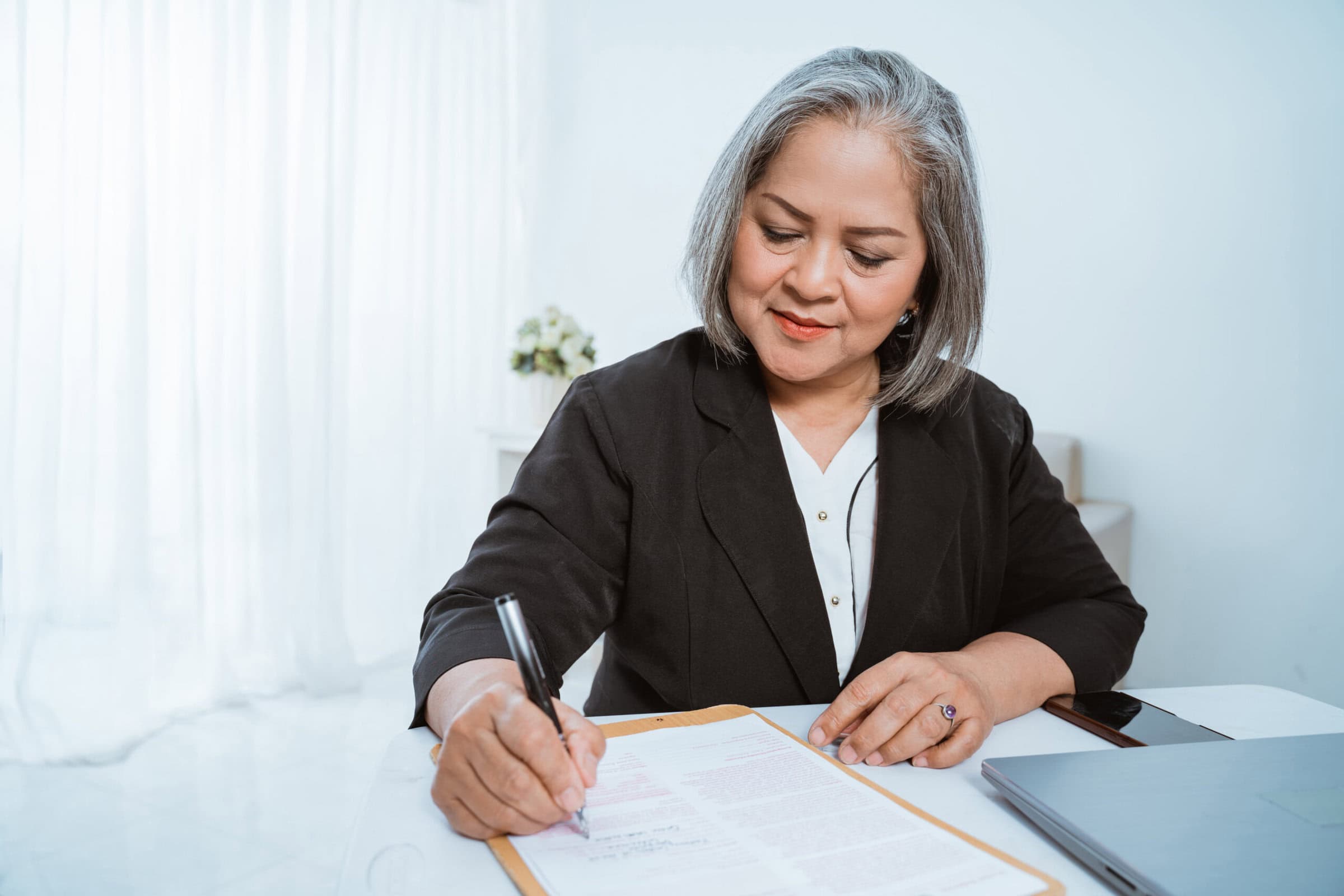 A woman is documenting her mentor coaching experience for her credential application
