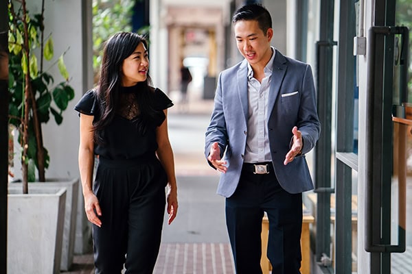 a coach and client walking and talking engaged respectfully