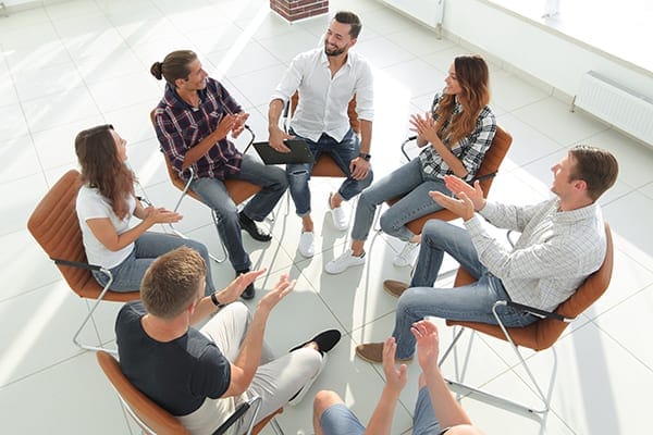 group coaching session with people positively engaged and interacting in the conversation